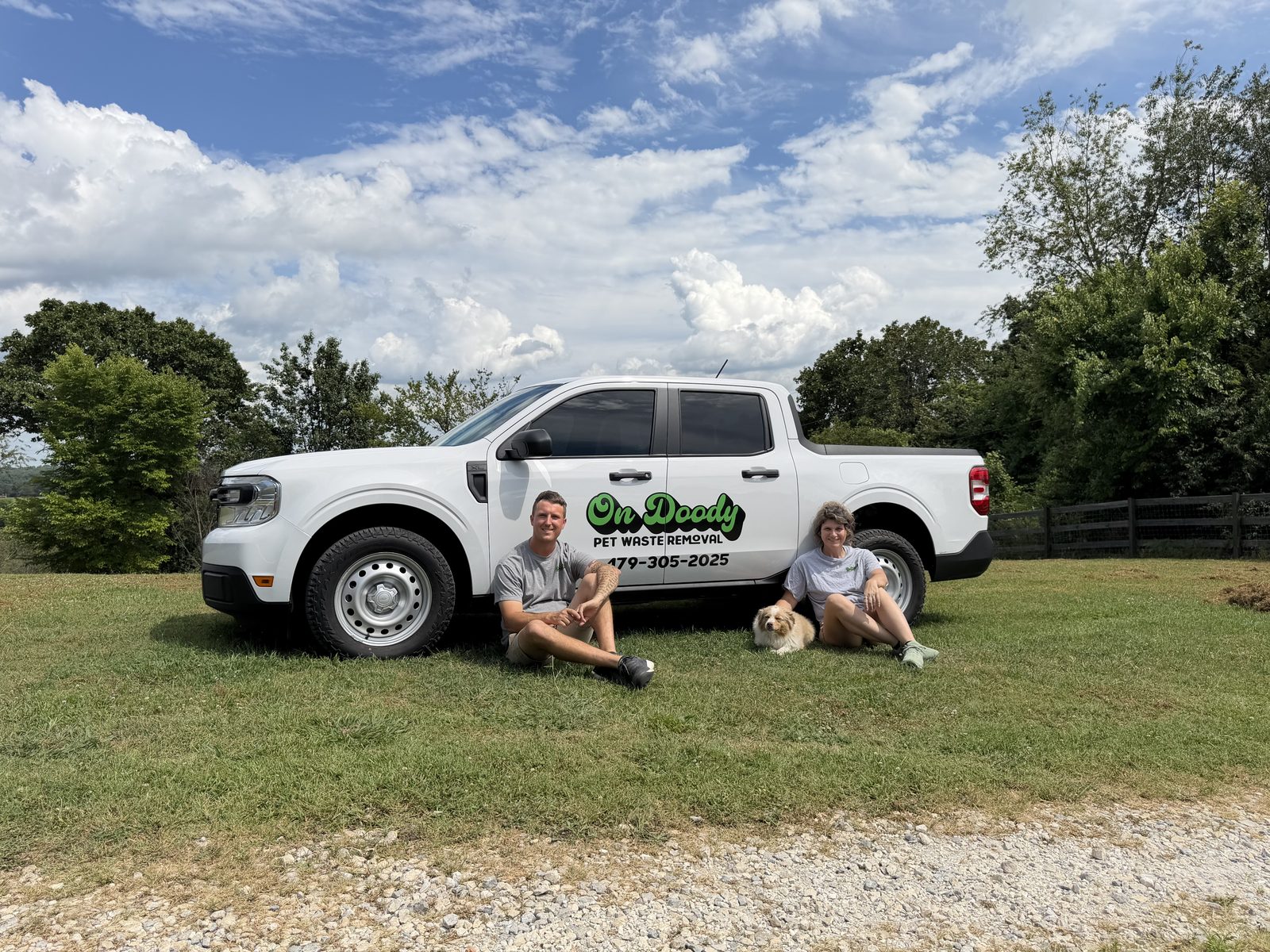 The On Doody owners with their dog by the company truck